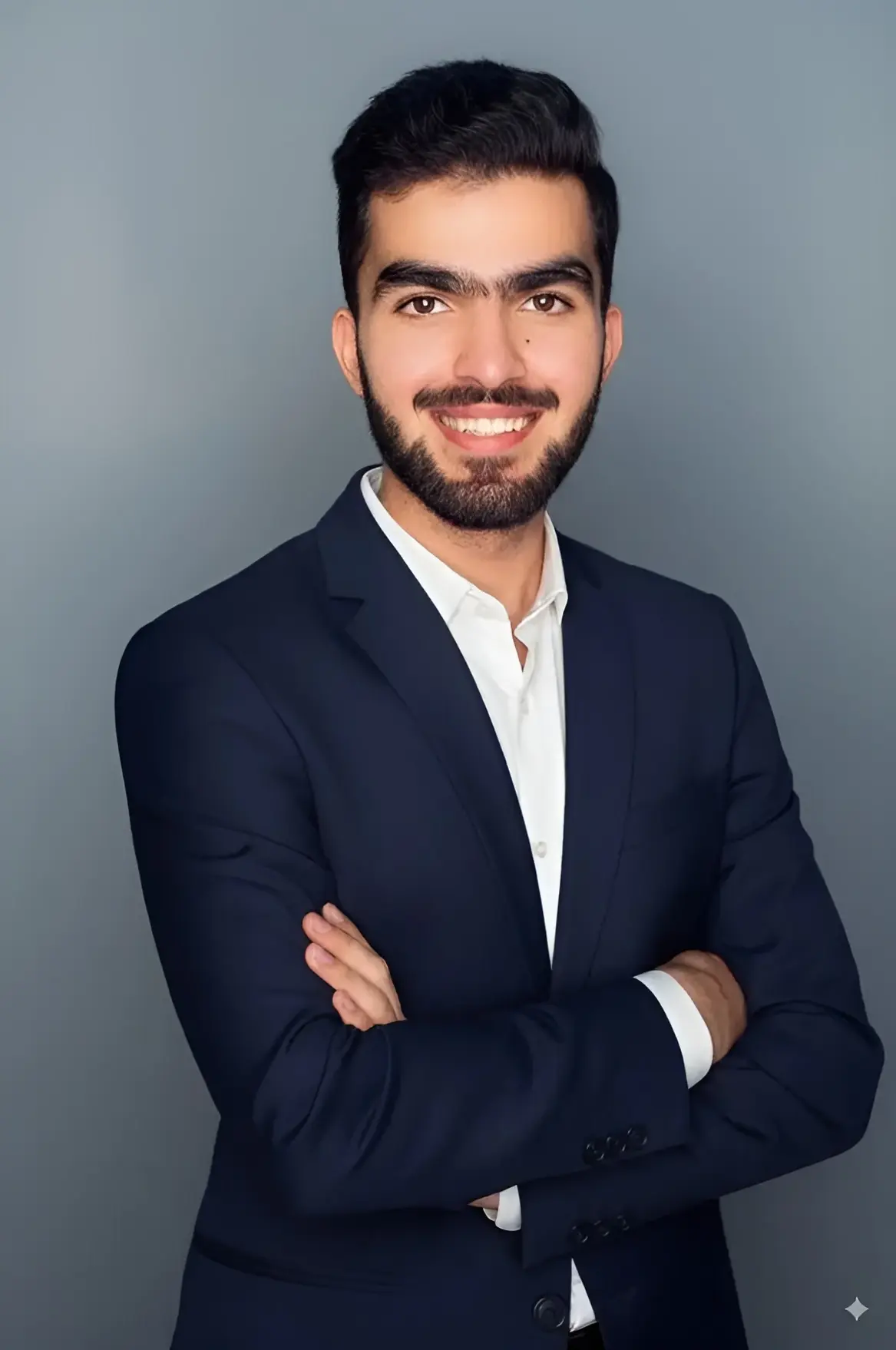 Hussain Jatoi smiling studio headshot in dark suit